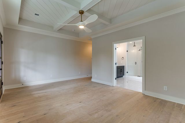 an empty room with fan and entrance