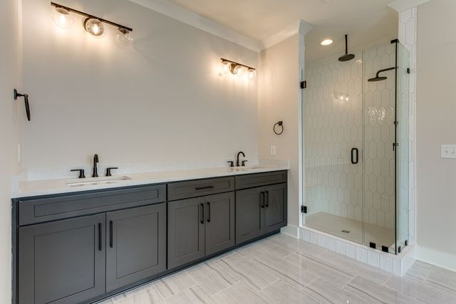 a spacious bathroom with double sink and shower