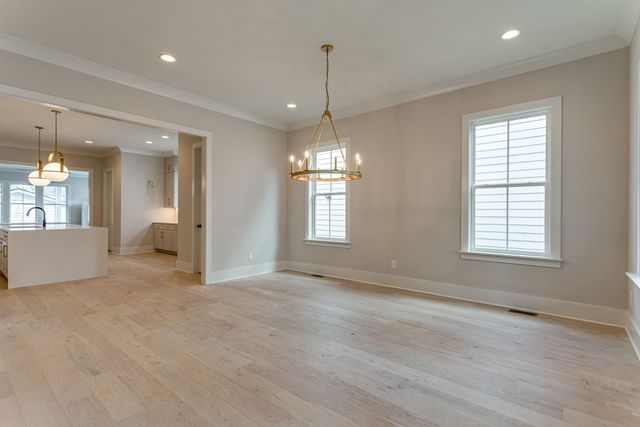 an empty room with windows and entrance