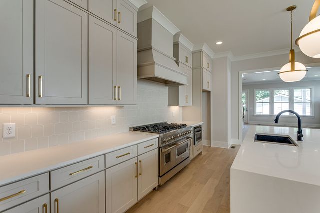 a kitchen with cabinets and stainless steel appliances