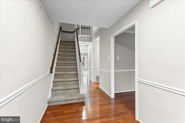 a view of entryway and hall with wooden floor