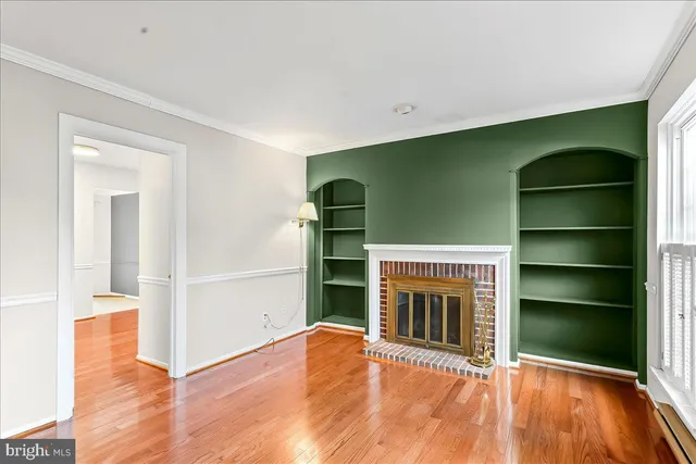 a view of an empty room with a fireplace