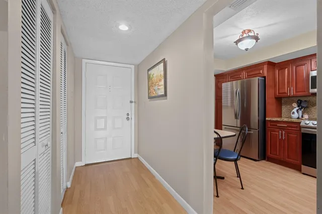 a kitchen with stainless steel appliances granite countertop a stove a sink dishwasher and wooden cabinets