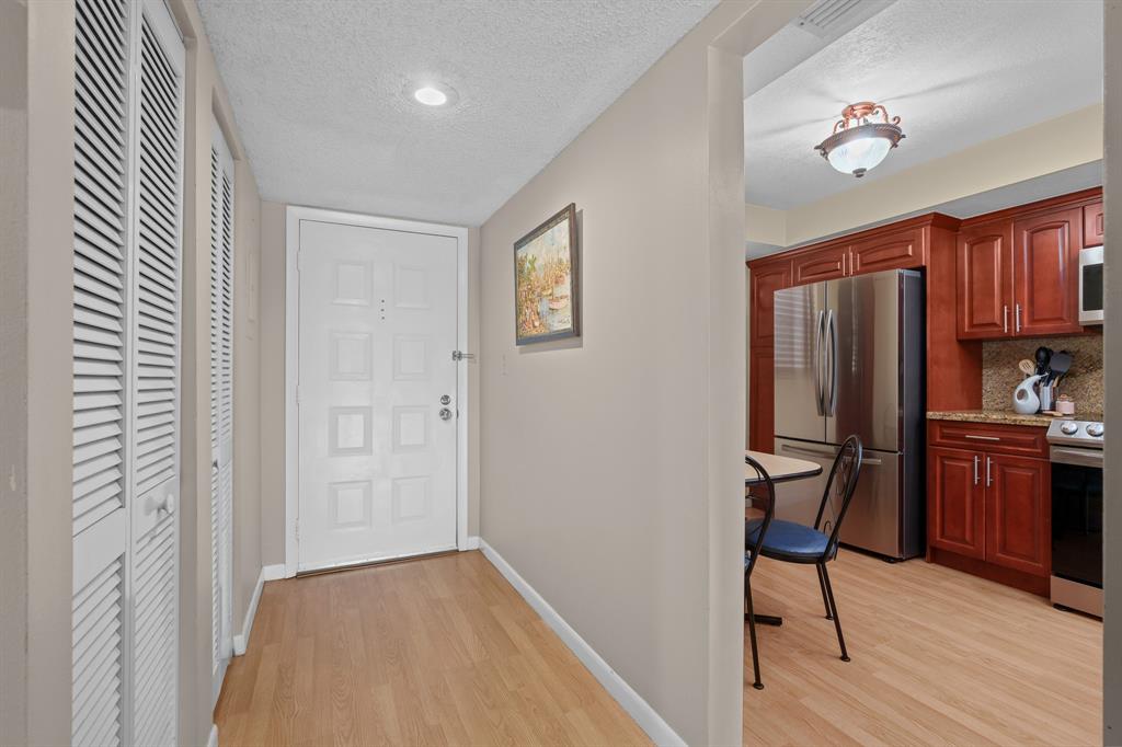 16051 Blatt Boulevard, Unit 212 Weston, FL 33326 - Photo 13 of 52 a view of kitchen with furniture and wooden floor