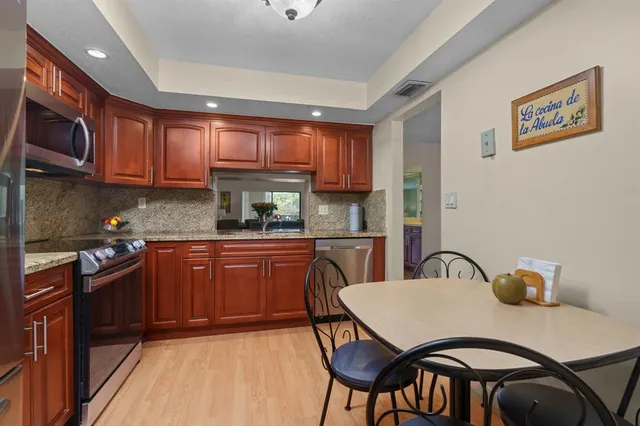 a kitchen with granite countertop a sink and cabinets