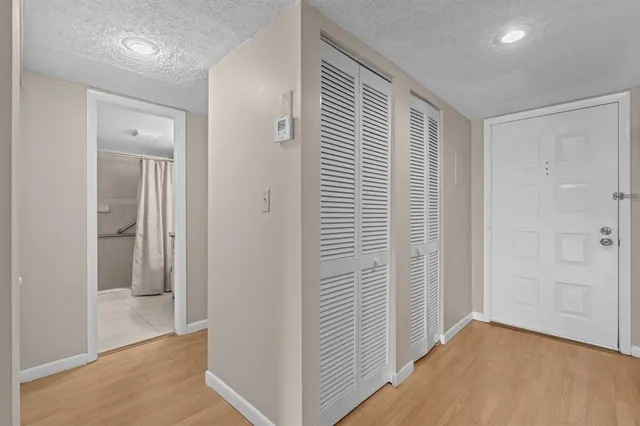 a view of hallway with stainless steel appliances
