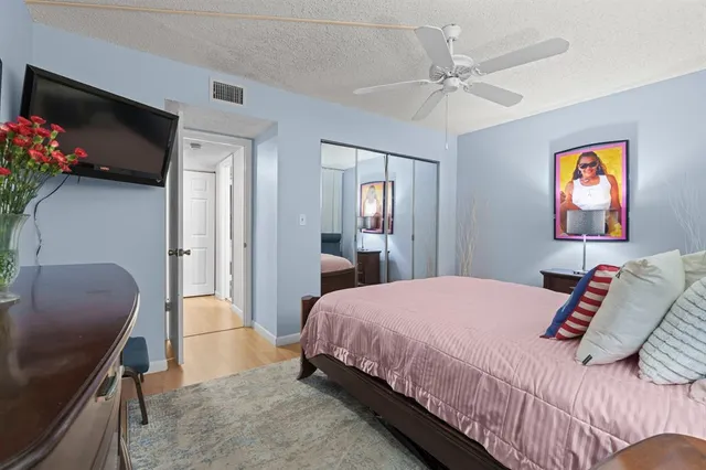 a bathroom with a granite countertop sink a mirror a shower and a mirror