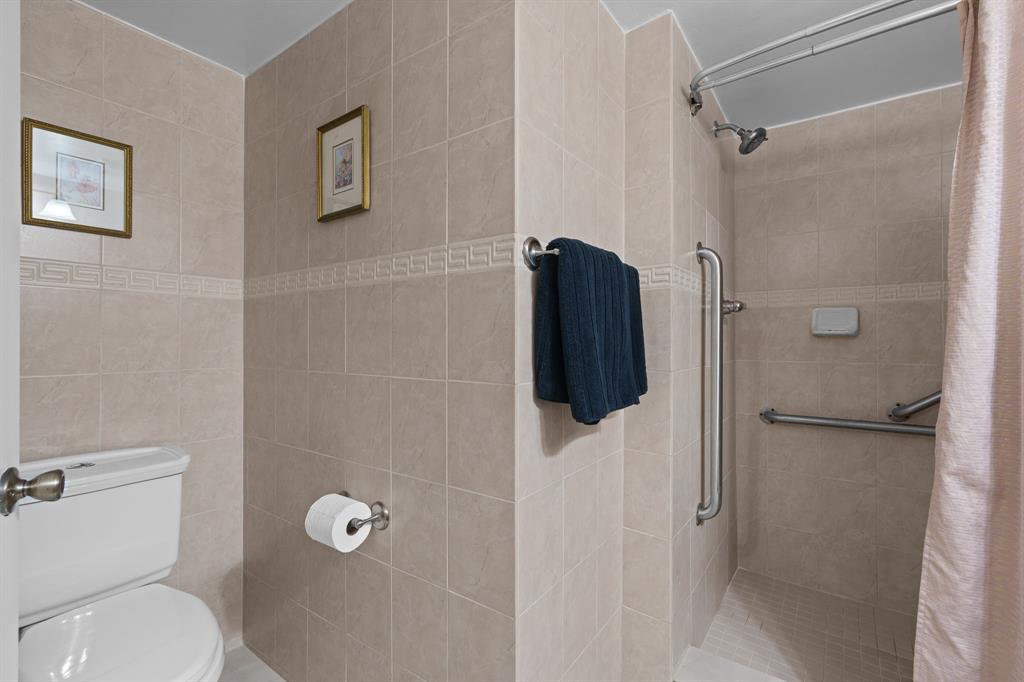 16051 Blatt Boulevard, Unit 212 Weston, FL 33326 - Photo 27 of 52 a bathroom with a toilet and a shower