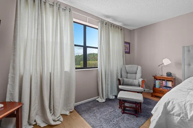 a bedroom with a bed and a chair