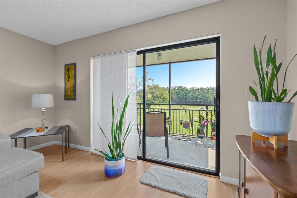 16051 Blatt Boulevard, Unit 212 Weston, FL 33326 - Photo 3 of 52 a view of a livingroom with furniture and a potted plant