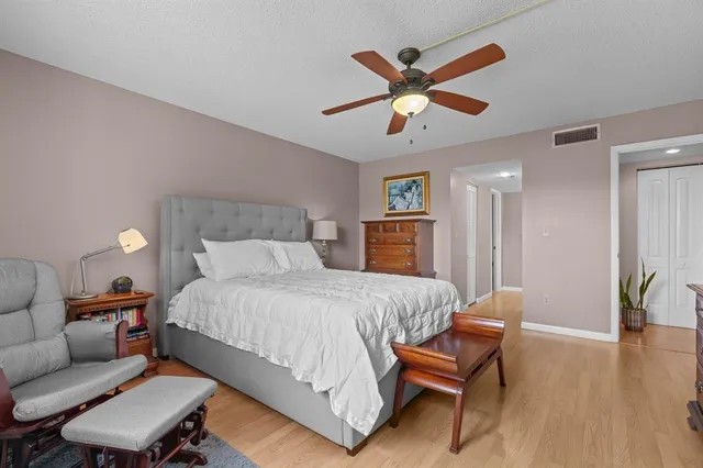 a view of a room that has a chair and white walls