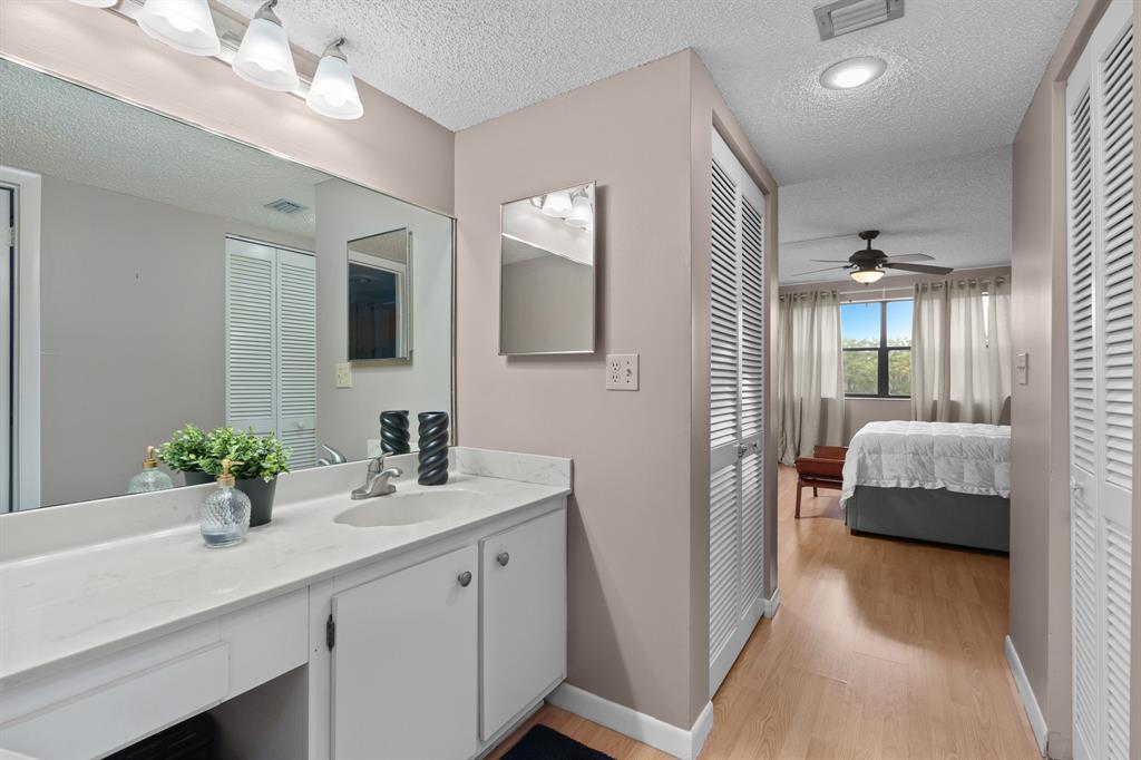 16051 Blatt Boulevard, Unit 212 Weston, FL 33326 - Photo 33 of 52 a en suite bathroom with a double vanity sink and a mirror