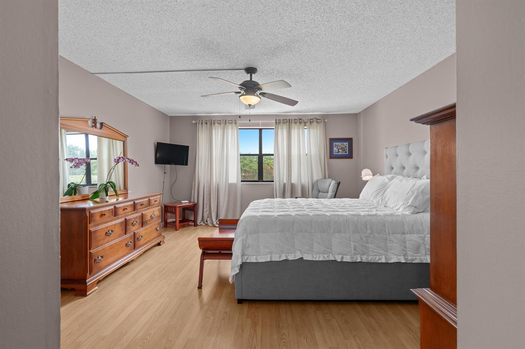 16051 Blatt Boulevard, Unit 212 Weston, FL 33326 - Photo 37 of 52 a bedroom with furniture and window