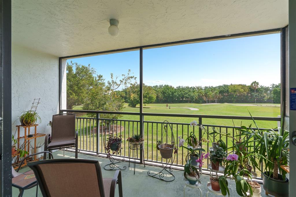 16051 Blatt Boulevard, Unit 212 Weston, FL 33326 - Photo 4 of 52 a view of a balcony with lake view and a potted plant
