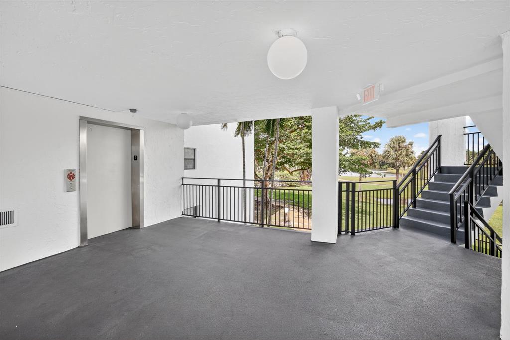 16051 Blatt Boulevard, Unit 212 Weston, FL 33326 - Photo 49 of 52 a view of an empty room with windows & view of bedroom