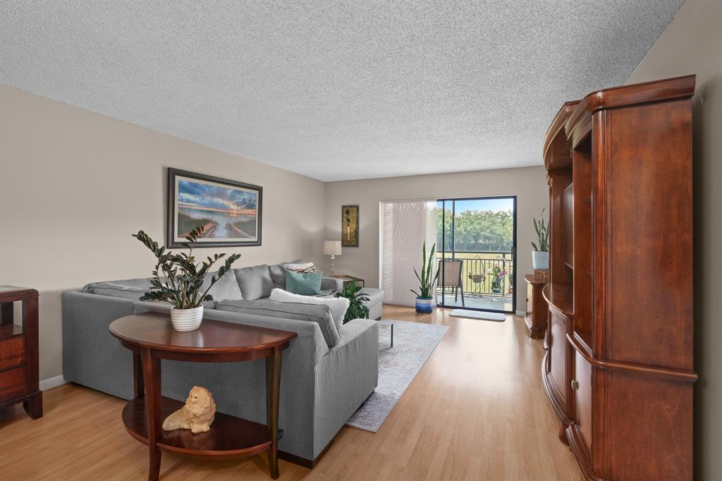 16051 Blatt Boulevard, Unit 212 Weston, FL 33326 - Photo 8 of 52 a living room with furniture and a window