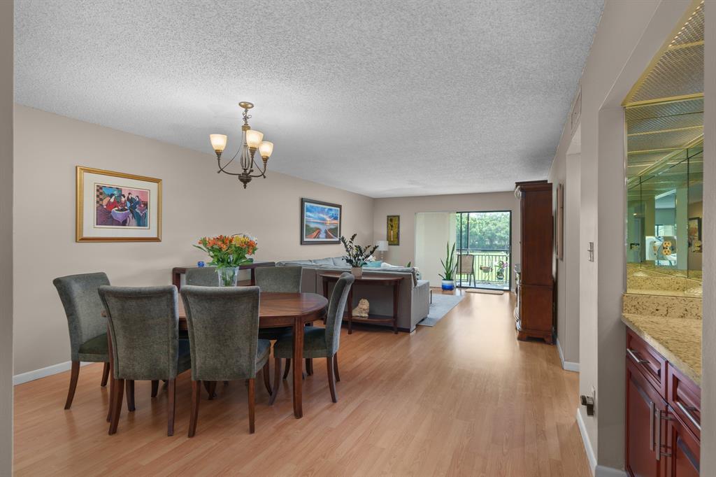 16051 Blatt Boulevard, Unit 212 Weston, FL 33326 - Photo 9 of 52 a view of a dining room with furniture window and wooden floor