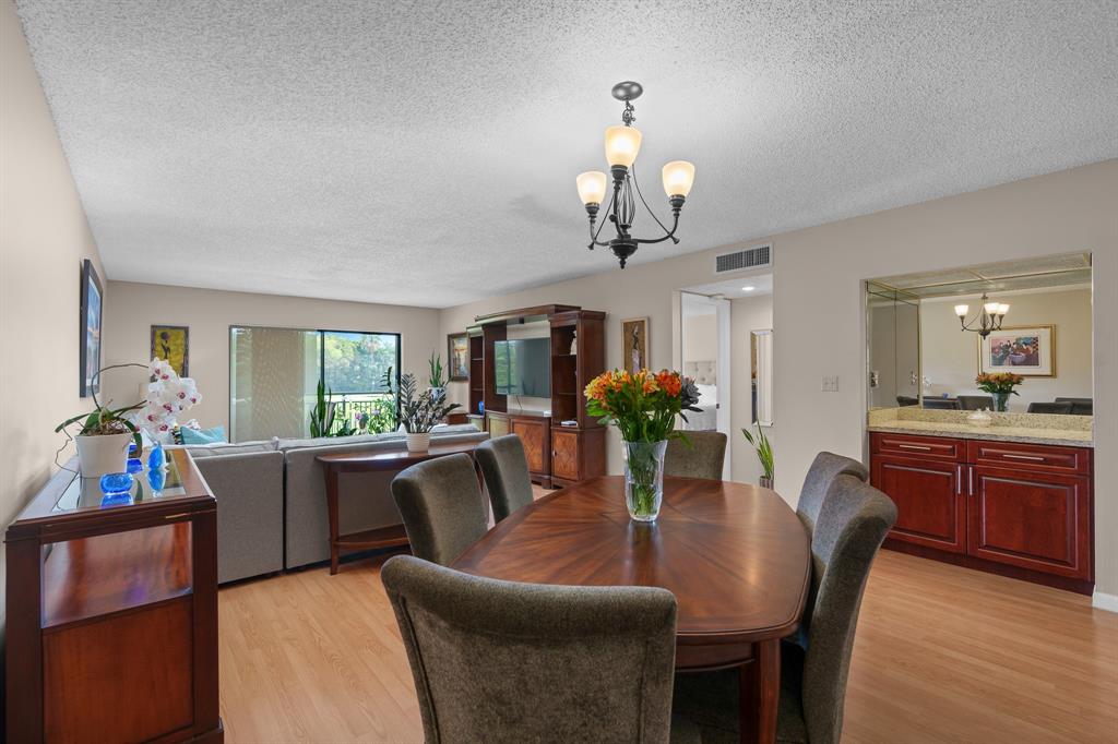 16051 Blatt Boulevard, Unit 212 Weston, FL 33326 - Photo 10 of 52 a view of a dining room with furniture window and wooden floor