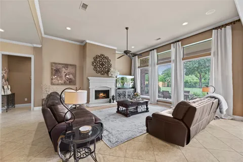 a living room with furniture fireplace and a large window