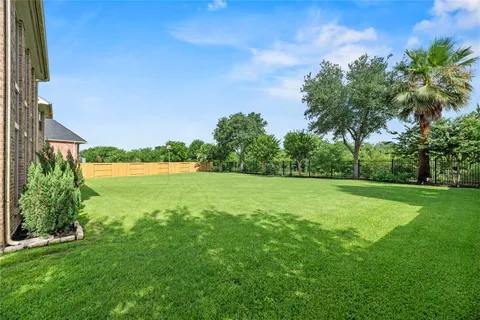 a view of yard with swimming pool and green space