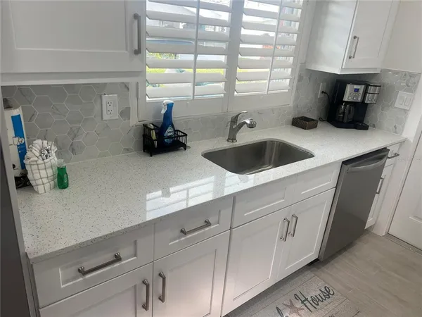a kitchen with a sink and cabinets