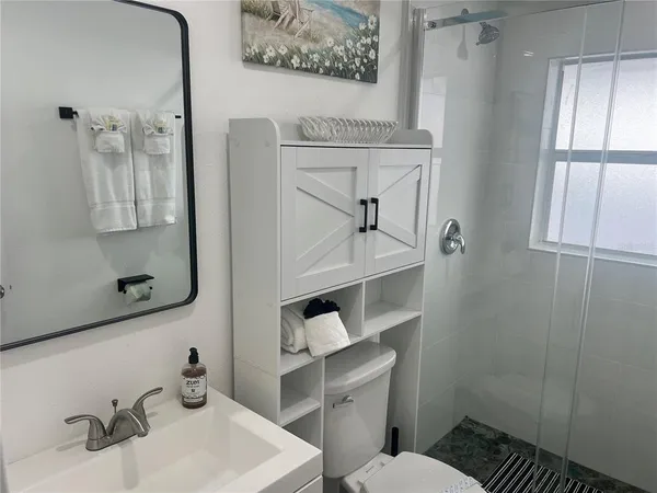 a bathroom with a sink toilet and vanity