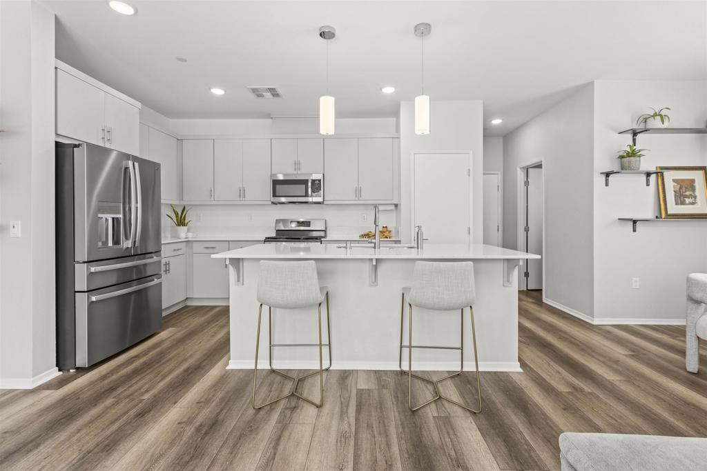 323 Citrine Trail Fallbrook, CA 92028 - Photo 12 of 21 a kitchen with kitchen island white cabinets and stainless steel appliances