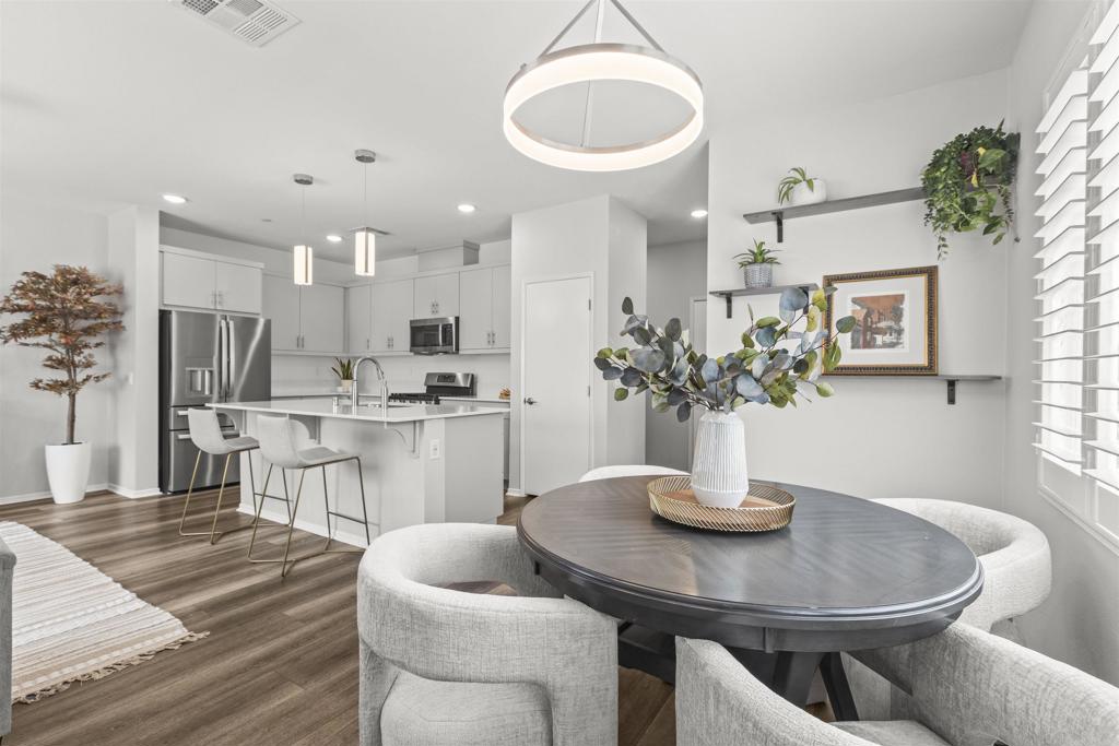 323 Citrine Trail Fallbrook, CA 92028 - Photo 14 of 21 a kitchen with a table chairs and refrigerator