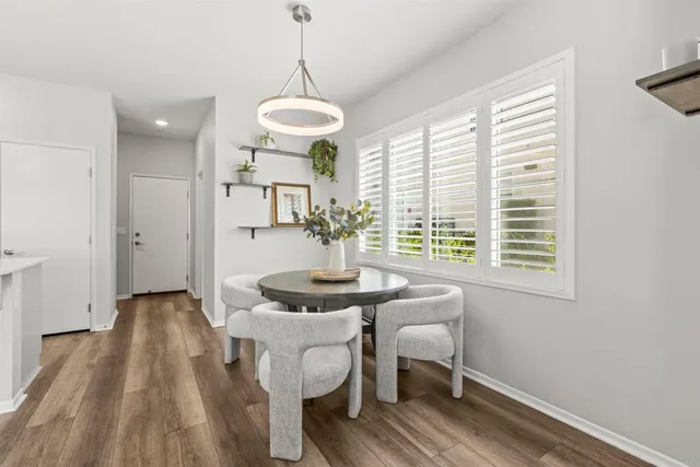 a view of a dining room with furniture window and wooden floor
