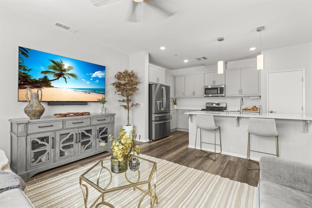 323 Citrine Trail Fallbrook, CA 92028 - Photo 7 of 21 a kitchen with stainless steel appliances kitchen island granite countertop a stove a sink and a refrigerator