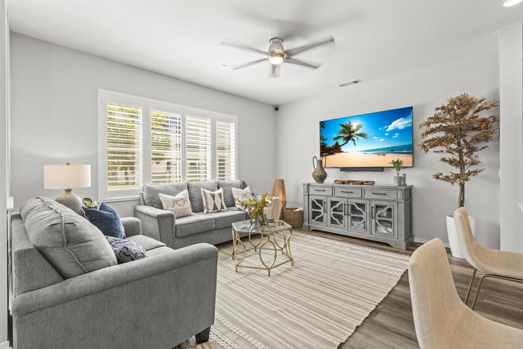 323 Citrine Trail Fallbrook, CA 92028 - Photo 8 of 21 a living room with furniture a fireplace and a flat screen tv
