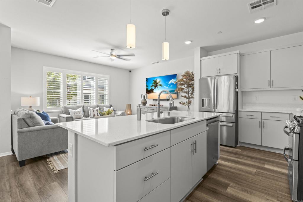 323 Citrine Trail Fallbrook, CA 92028 - Photo 9 of 21 a kitchen with refrigerator cabinets and a sink