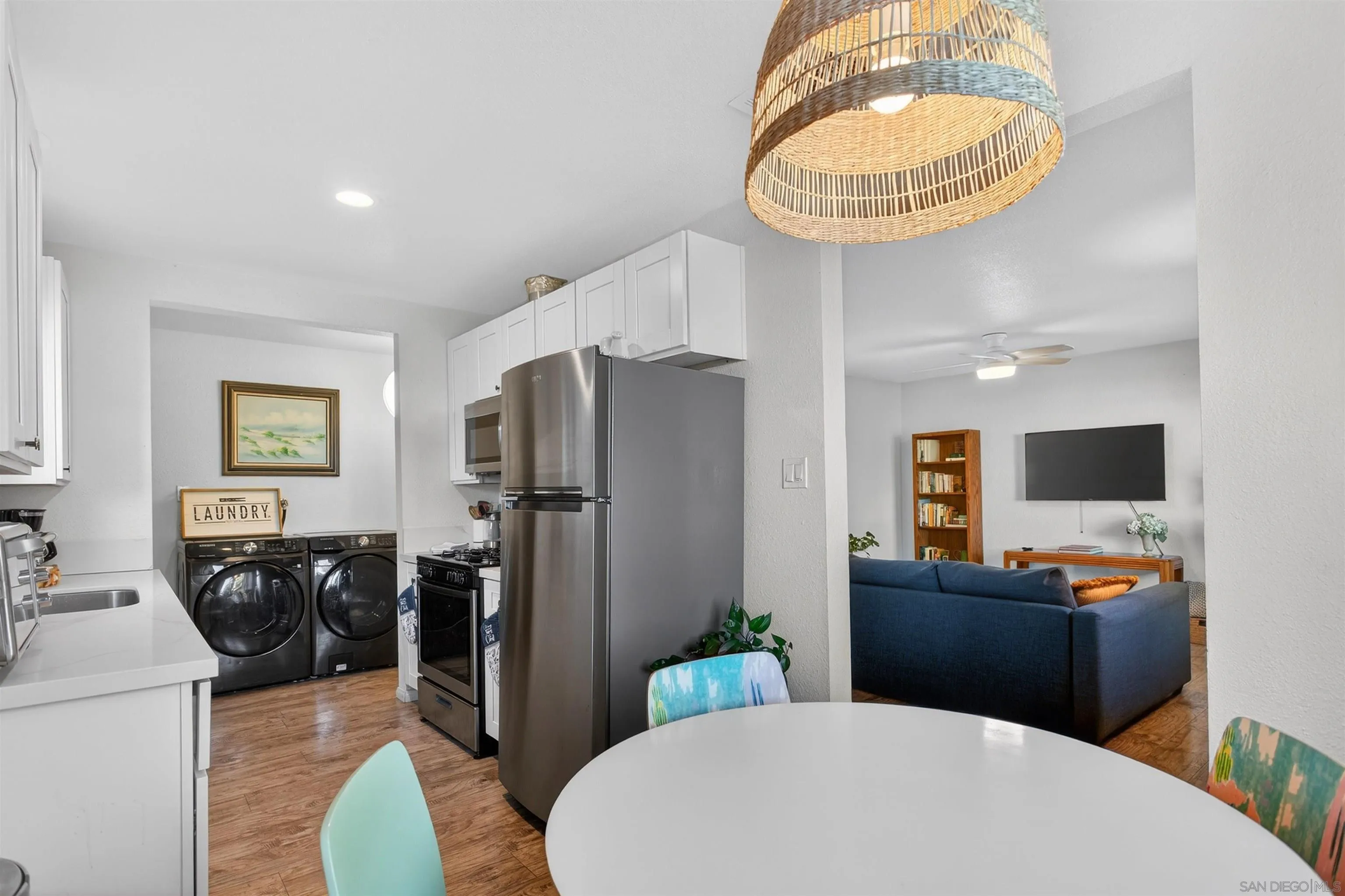 3548 De Leone Road San Marcos, CA 92069 - Photo 11 of 46 a kitchen with stainless steel appliances a table and chairs in it