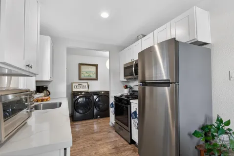 a kitchen with a sink a stove and cabinets