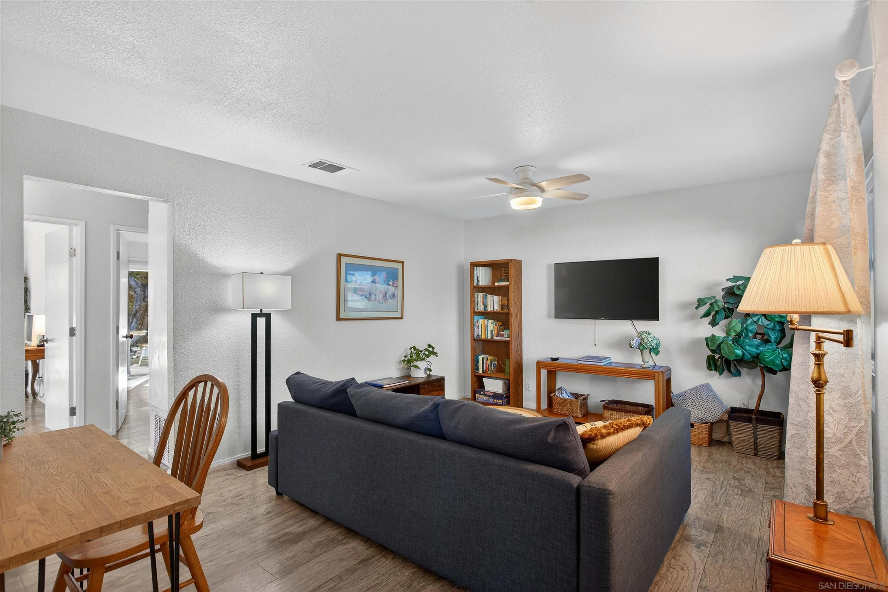3548 De Leone Road San Marcos, CA 92069 - Photo 7 of 46 a living room with furniture a flat screen tv and a table