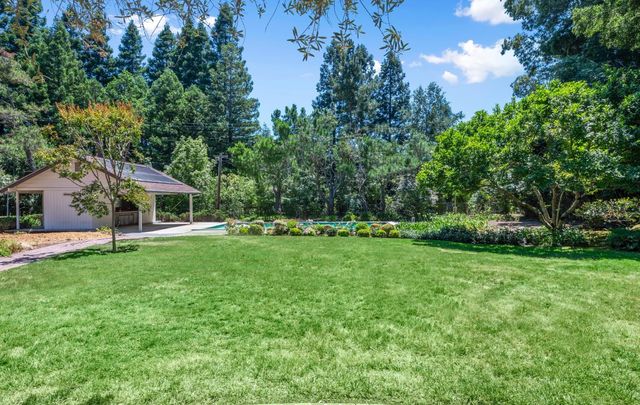 a front view of a house with a garden