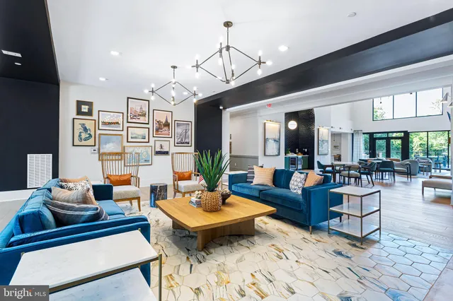 a living room with furniture a rug and a chandelier