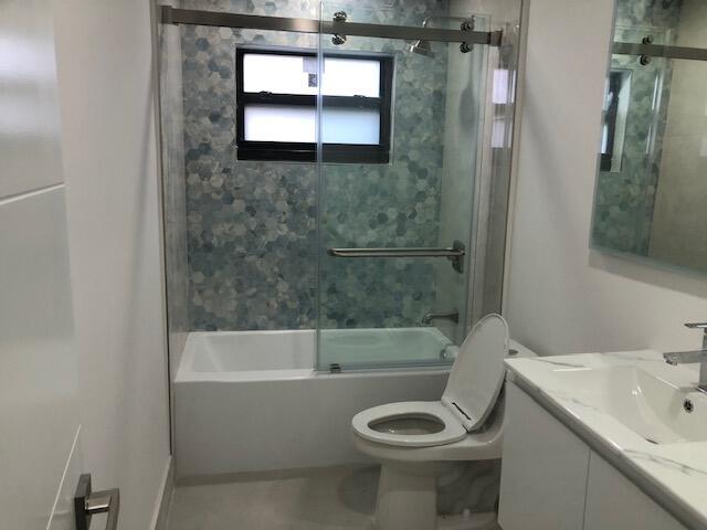 22171 Hollyhock Trail Boca Raton, FL 33433 - Photo 17 of 24 a bathroom with a sink toilet and shower