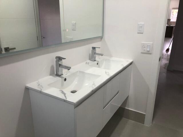 22171 Hollyhock Trail Boca Raton, FL 33433 - Photo 18 of 24 a bathroom with a sink and a mirror