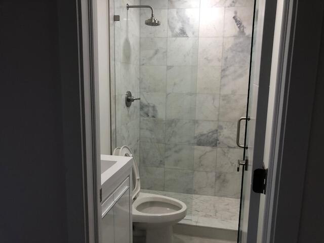 22171 Hollyhock Trail Boca Raton, FL 33433 - Photo 21 of 24 a bathroom with a granite countertop toilet a sink and a shower