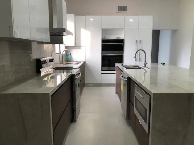 a kitchen with stainless steel appliances granite countertop a sink stove and refrigerator