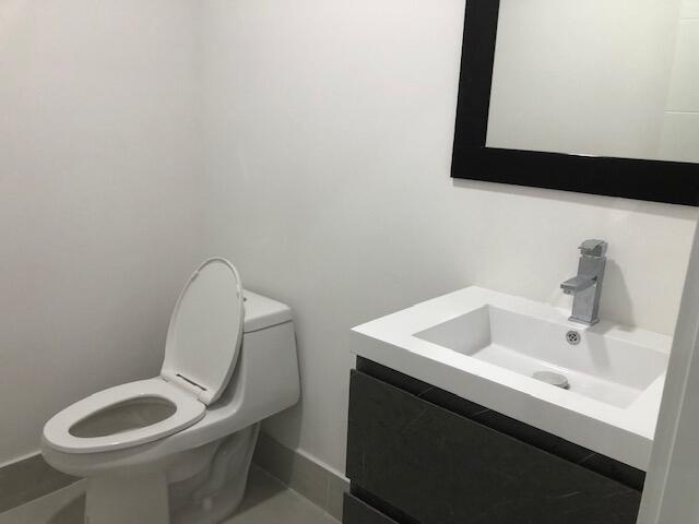 22171 Hollyhock Trail Boca Raton, FL 33433 - Photo 7 of 24 a bathroom with a toilet sink and mirror