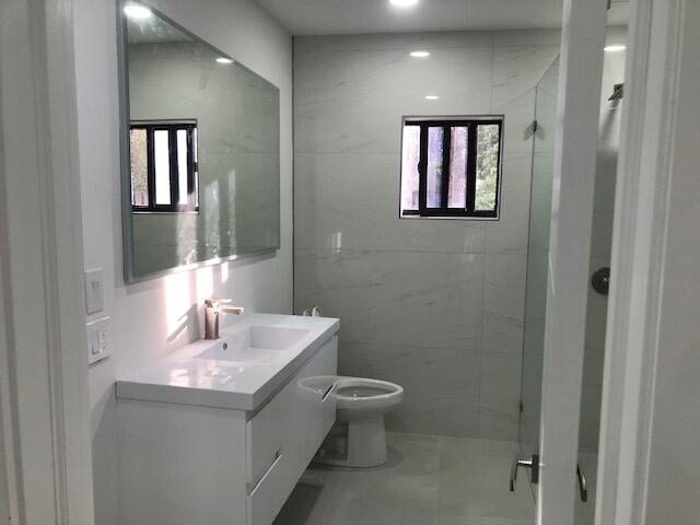 22171 Hollyhock Trail Boca Raton, FL 33433 - Photo 9 of 24 a bathroom with a toilet sink and mirror