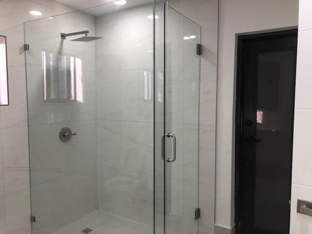 22171 Hollyhock Trail Boca Raton, FL 33433 - Photo 10 of 24 a bathroom with a glass shower door