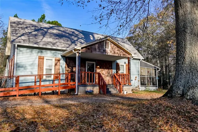 a view of a house with a backyard and porch