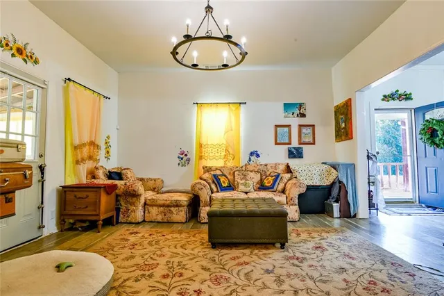 a living room with patio furniture and a chandelier