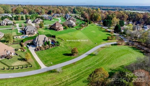 an aerial view of residential houses with outdoor space and street view
