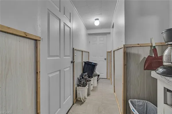 a view of a hallway with workspace and a couch