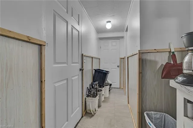 a view of a hallway with workspace and a couch