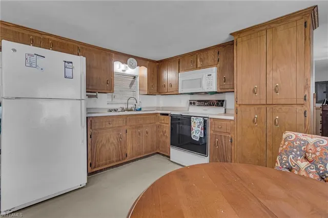 a kitchen with a sink appliances and cabinets